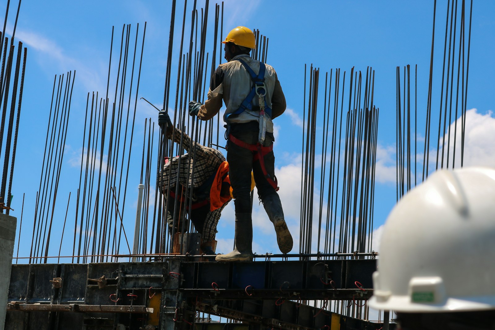 a man standing on top of a metal structure, contractors'